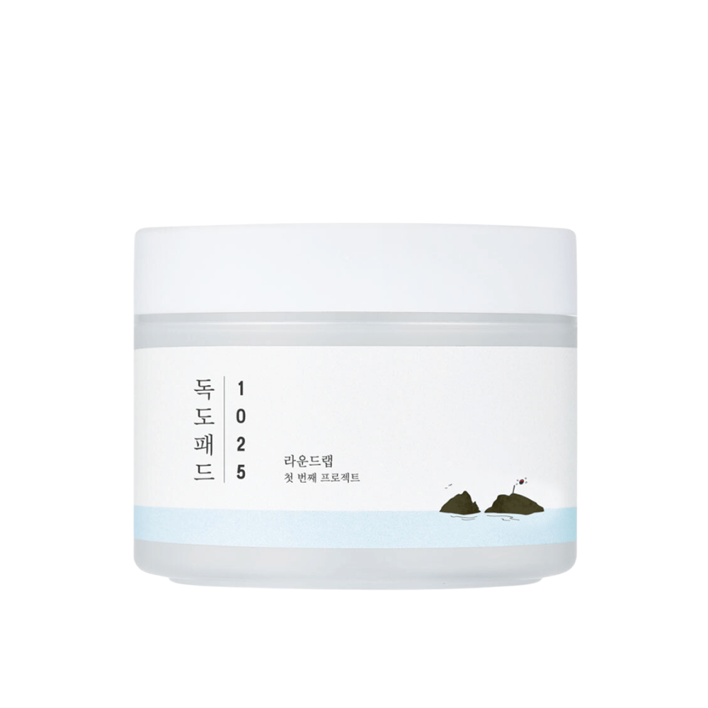 A closed white jar of 1025 Dokdo Pads with a simple design and sea motif on the label, against a white background.