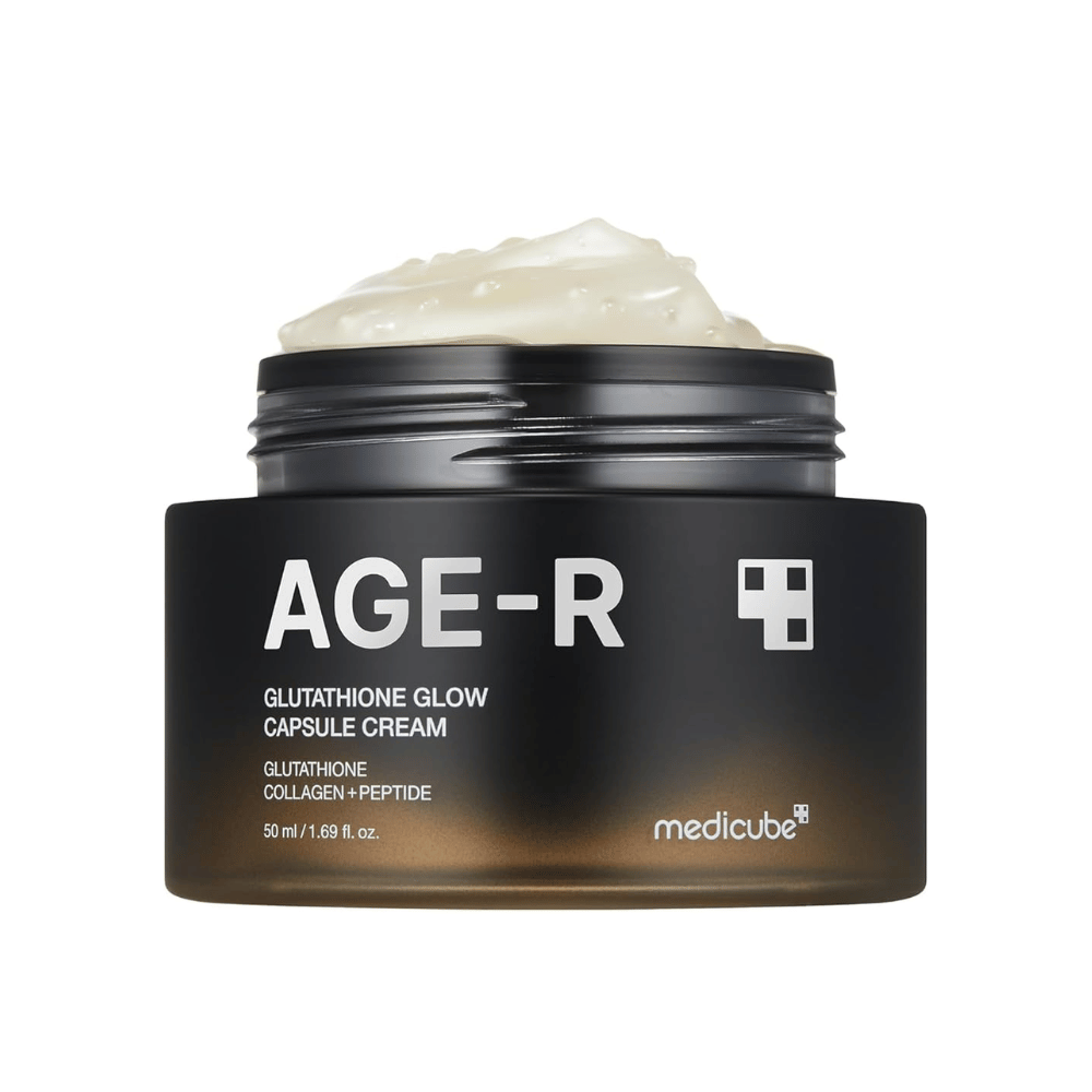 Jar of Medicube Age-R Glutathione Glow Capsule Cream, a cream containing glutathione, collagen, and peptide. The product is designed to give the skin radiance and improve elasticity. The cream's soft texture is shown in the jar.