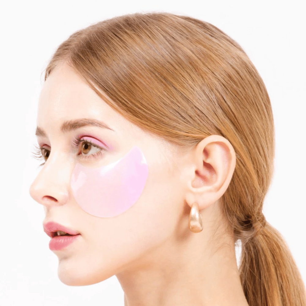 Model wears a pink hydrogel eye patch under the eye, moisturizing and skin rejuvenating.
