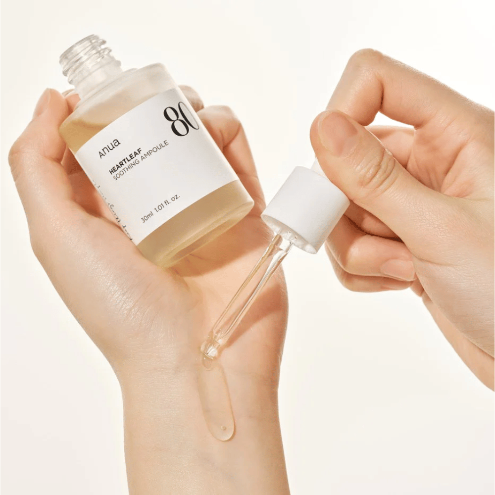 A hand holding a Heartleaf 80% Soothing Ampoule 30ml from Anua.