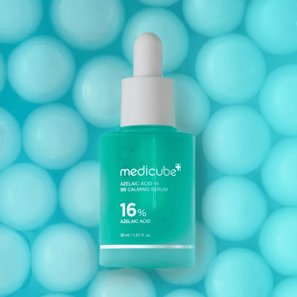 Campaign image of Medicube Azelaic Acid 16 BB Calming Serum against a turquoise background with soft spheres symbolizing hydration, a soothing effect, and even skin texture.