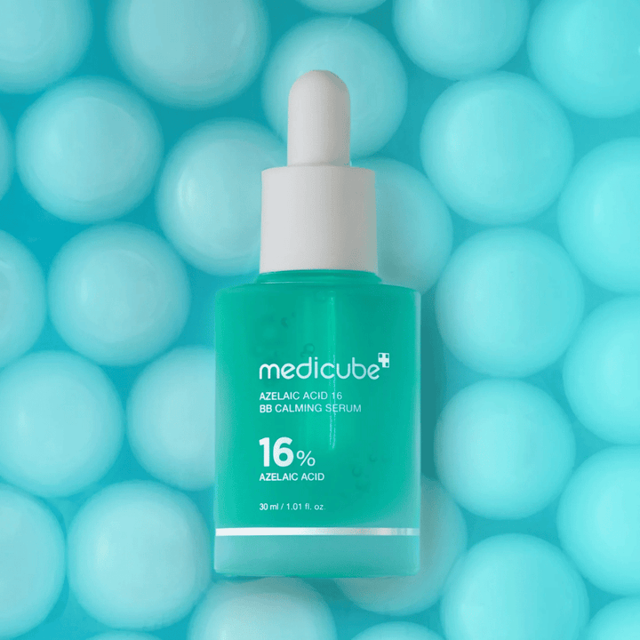 Campaign image of Medicube Azelaic Acid 16 BB Calming Serum against a turquoise background with soft spheres symbolizing hydration, a soothing effect, and even skin texture.