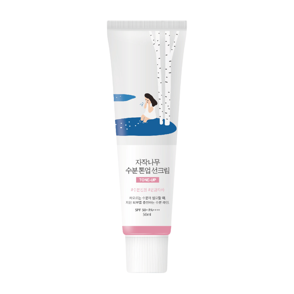 A white tube with Birch Juice Moisturizing Tone Up Sunscreen. The tube has an illustration of a woman sitting by a birch tree next to a puddle. The text on the tube is in Korean and indicates that the product has SPF 50+ PA++++ and contains 50 ml.