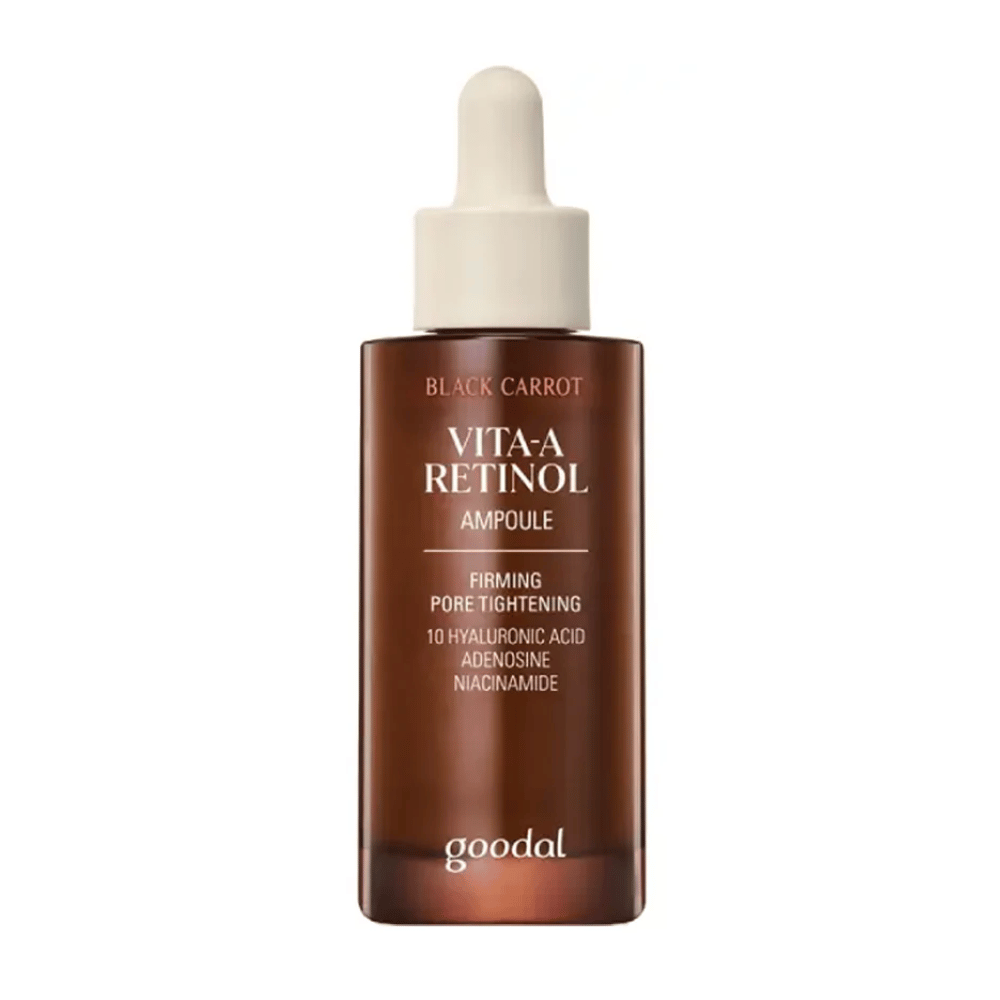 The bottle with Goodal Black Carrot Vita-A Retinol Firming Ampoule is displayed. It has a beige dropper and a dark brown bottle. The label describes the product as "Vita-A Retinol Ampoule" and mentions features like "Firming Pore Tightening", as well as ingredients such as 10% hyaluronic acid, adenosine, and niacinamide.