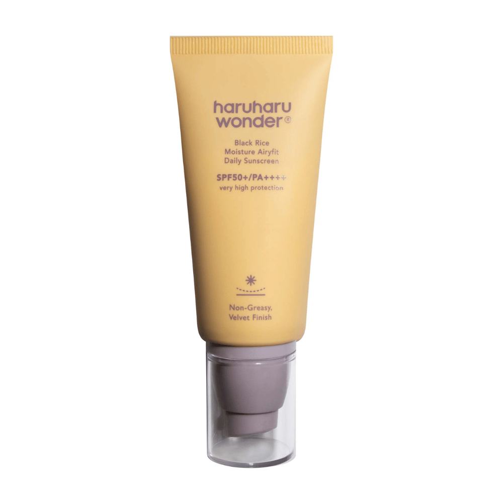 A yellow tube with Haruharu Wonder Black Rice Moisture Airyfit Daily Sunscreen SPF 50+ PA++++. The tube has a transparent cap and text describing the sunscreen's high level of protection and its non-greasy, velvety finish.