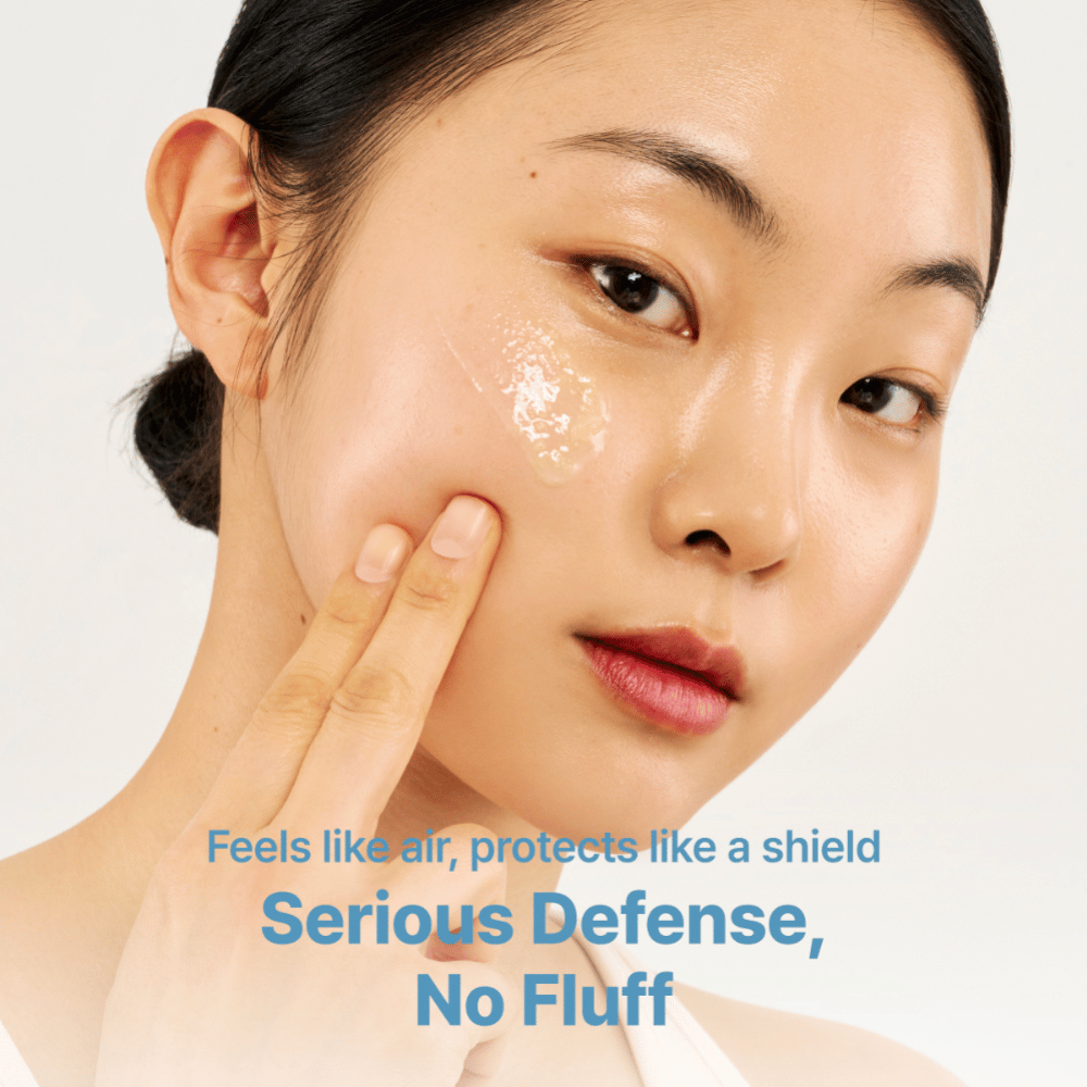 Tage Cica-Tree Water Jelly Sun Serum SPF 50+ is applied to a model's cheek. Transparent gel gives the skin a glossy finish.