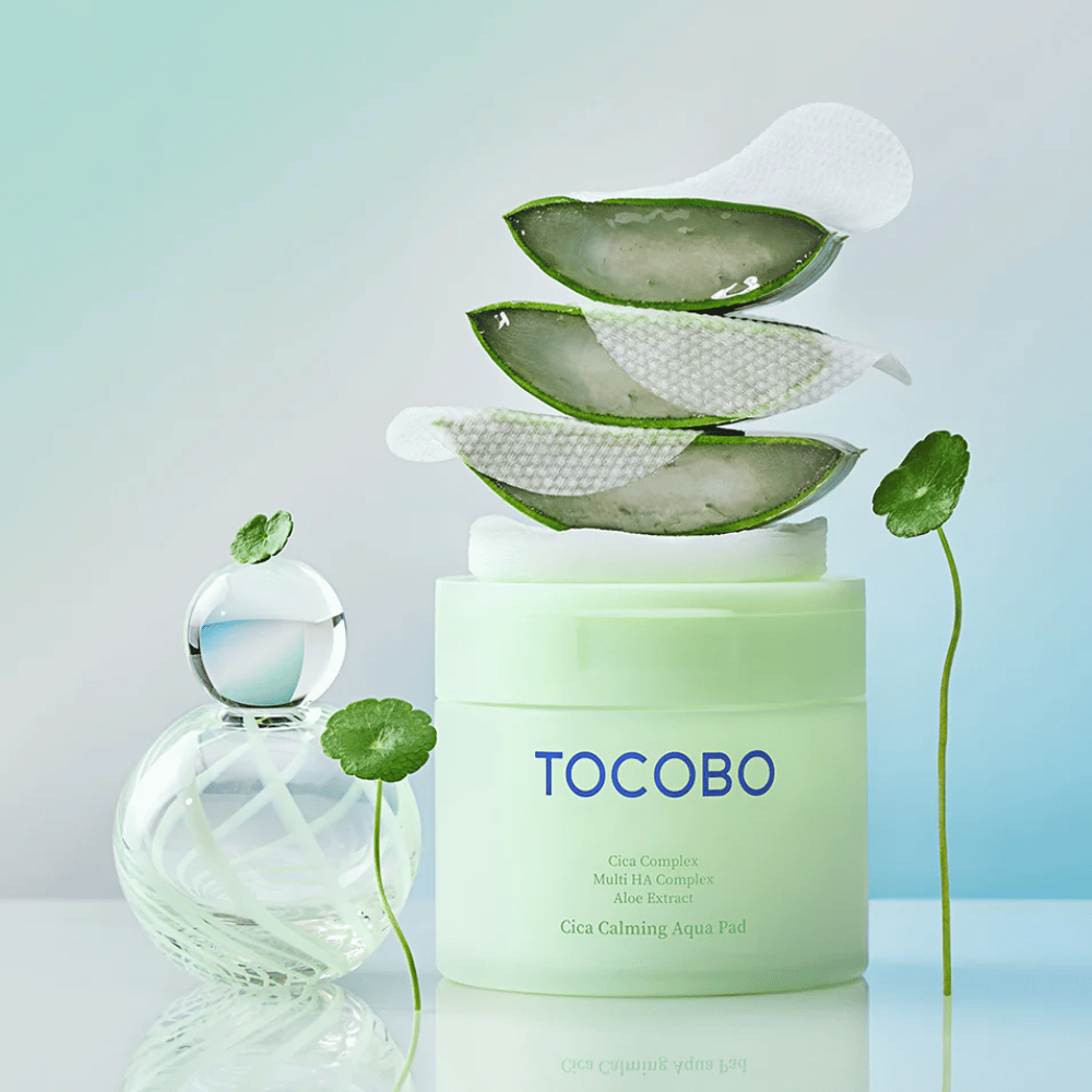 TOCOBO Cica Calming Aqua Pad is shown together with toner pads, aloe vera, and centella asiatica. The image highlights the product's moisturizing and soothing ingredients.
