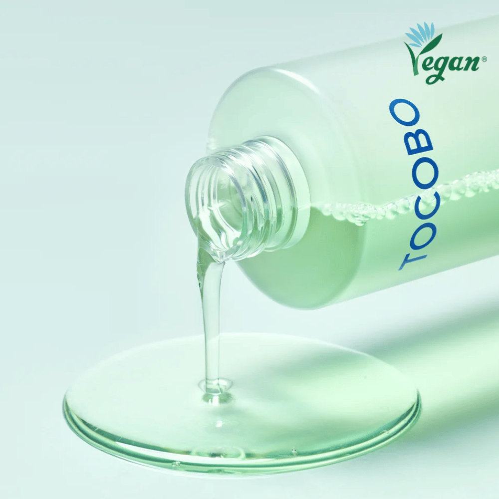 Close-up of TOCOBO Cica Calming Aqua Toner being poured out to highlight the product’s clear, light, and cooling texture.