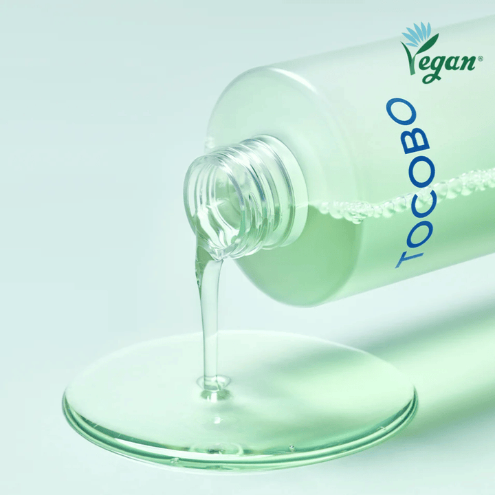 Close-up of TOCOBO Cica Calming Aqua Toner being poured out to highlight the product’s clear, light, and cooling texture.