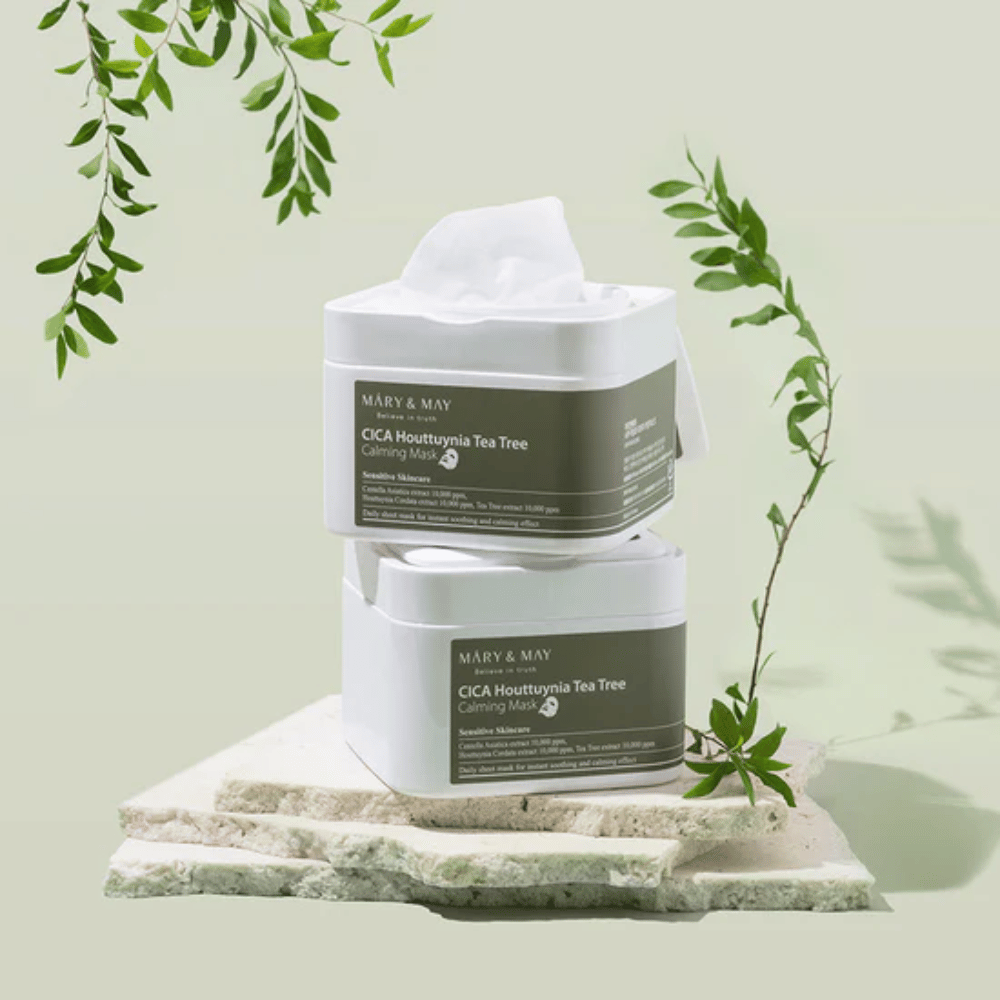 Two jars of Mary & May Cica Houttuynia Tea Tree Calming Mask placed on natural stone with green plant details – soothing sheet masks for sensitive skin.