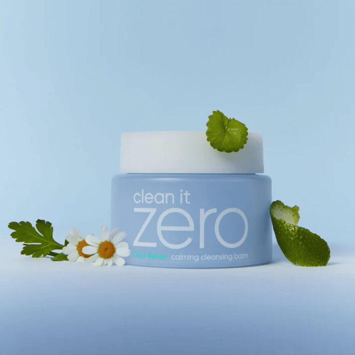 Clean It Zero Cica-Relief Calming Cleansing Balm placed with plants and flowers, illustrating gentle cleansing with soothing CICA for sensitive and irritated skin.