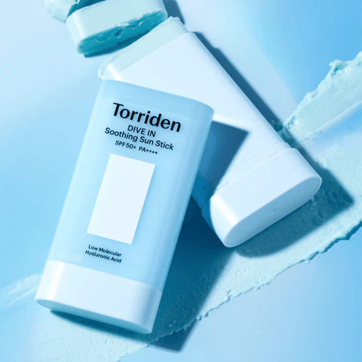 Torriden DIVE IN Soothing Sun Stick SPF50+ PA++++ together with smeared product texture illustrating the moisturizing and lightweight application.