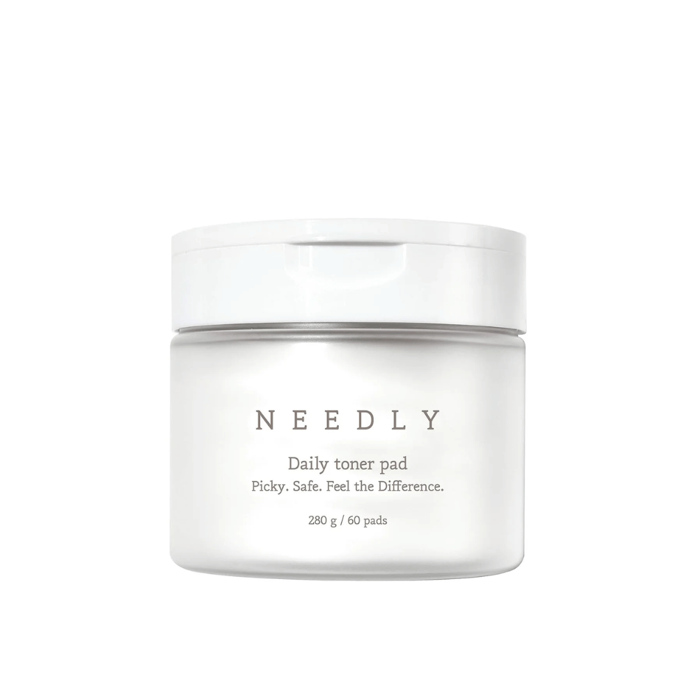 A white jar with Needly Daily Toner Pad. The packaging has minimalist text describing the product and contains 280 g, equivalent to 60 toner pads. The text reads 'Picky. Safe. Feel the Difference.