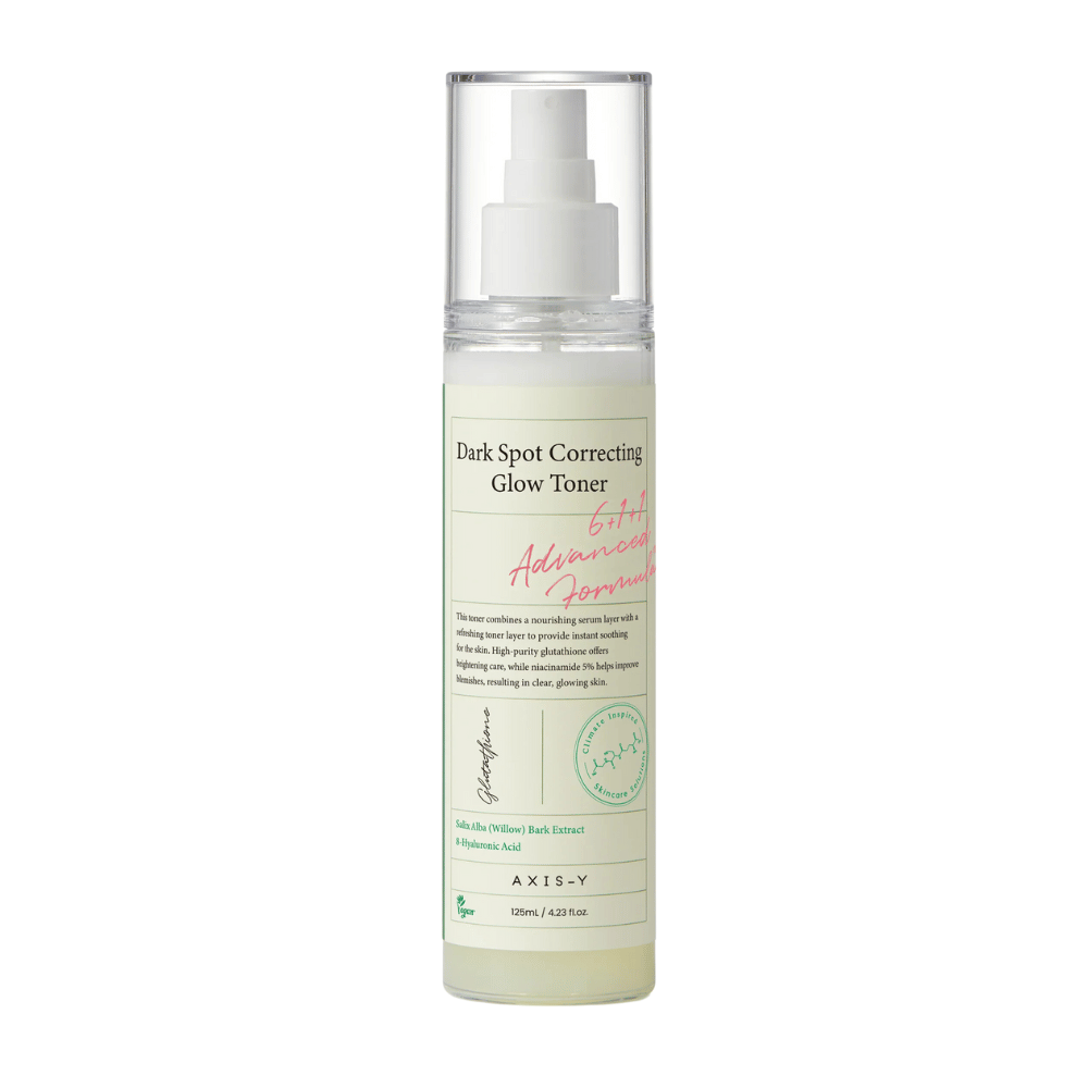 An image of a bottle of the product "AXIS-Y Dark Spot Correcting Glow Toner". The bottle is transparent with a white label and text in black and green. The product is a toner in spray form, and the bottle contains 125 ml (4.23 fl. oz). The label mentions key ingredients such as Willow Bark Extract and Hyaluronic Acid.
