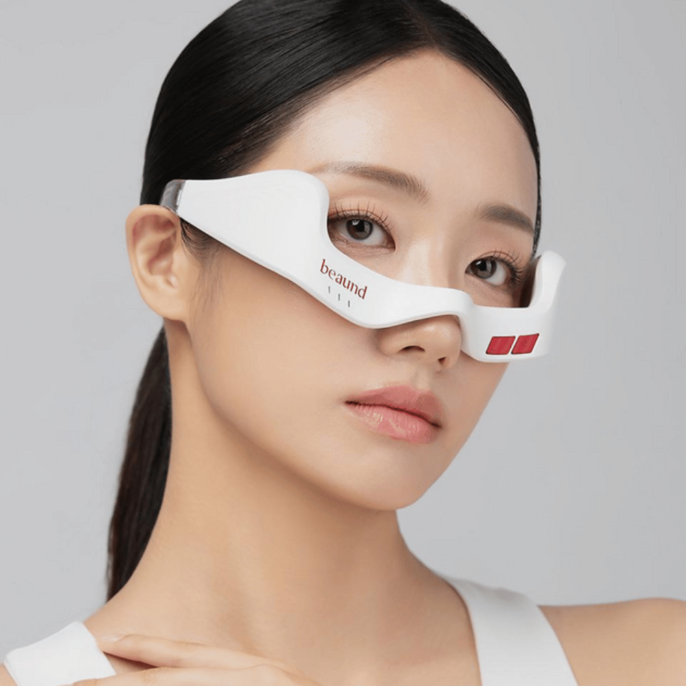 Close-up of a model wearing Beaund Eye Rejuv to highlight the ergonomic fit and sleek design around the eye area.