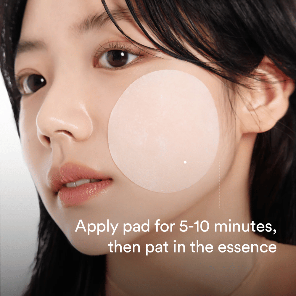 Woman applying a round toner pad on the cheek for hydrating and radiance-boosting skincare.