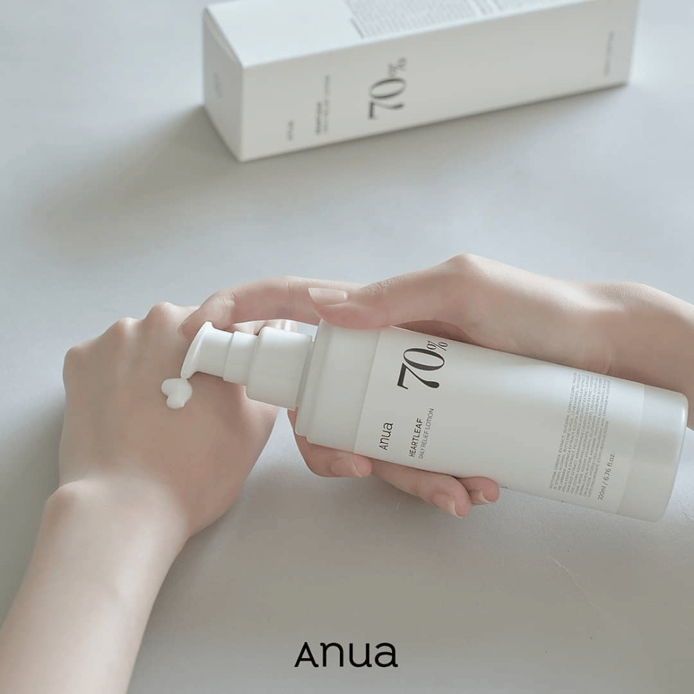 A person is holding a bottle Anua Heartleaf 70% Daily Lotion 200ml.