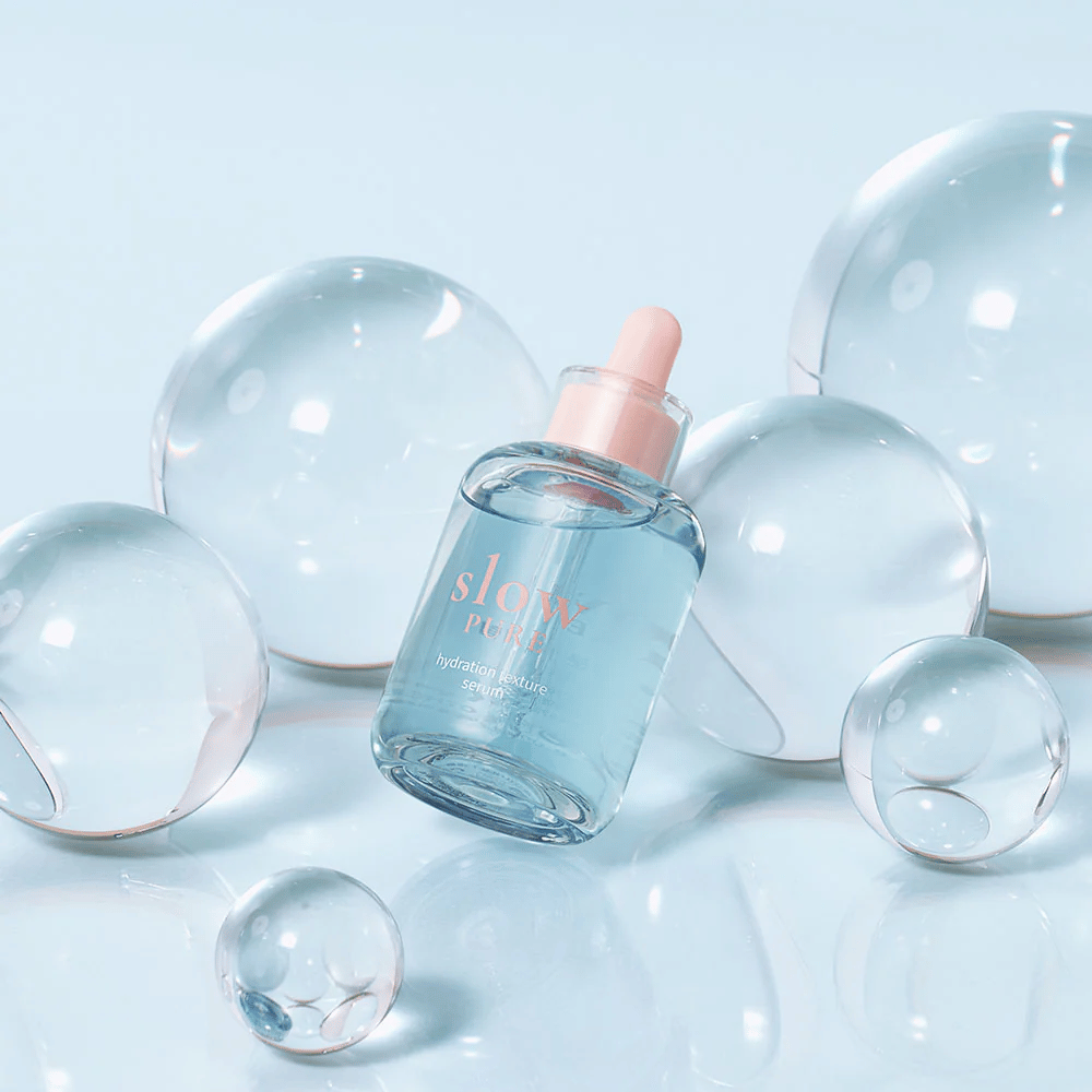 Slow Pure Hydration Texture Serum placed among transparent bubbles, symbol for intense hydration.