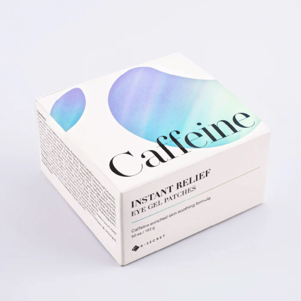 Packaging of K-Secret Instant Relief Eye Gel Patches with caffeine in white design with blue and green tones.