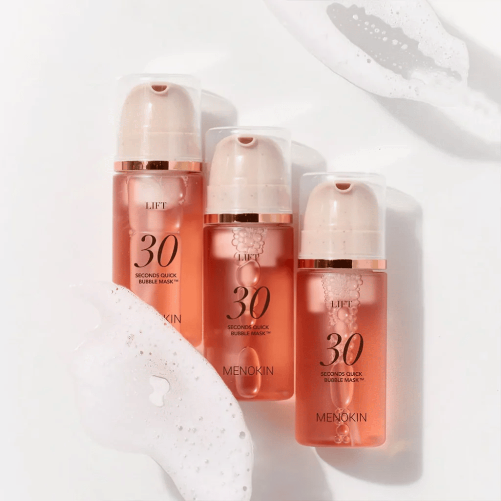 Aesthetic product image with three bottles of MENOKIN LIFT 30 Seconds Quick Bubble Mask surrounded by soft foam that highlights the bubbling and cleansing effect.