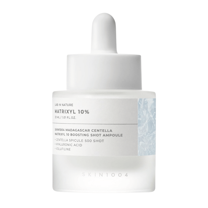 Close-up of SKIN1004 Madagascar Centella Matrixyl 10 Boosting Shot Ampoule showing pipette and label – high-concentration peptide serum for skin elasticity and hydration.