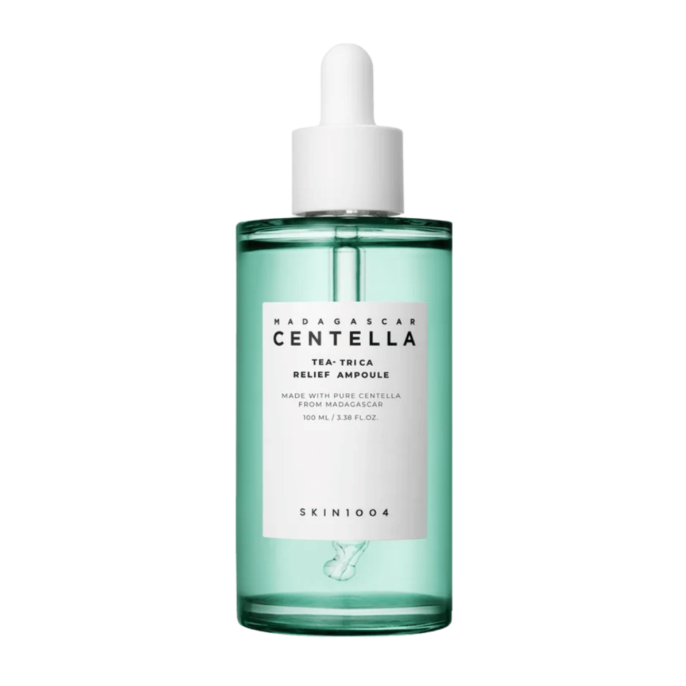 Green transparent bottle with white label and pipette – SKIN1004 Madagascar Centella Tea-Trica Relief Ampoule 100 ml against a white background.