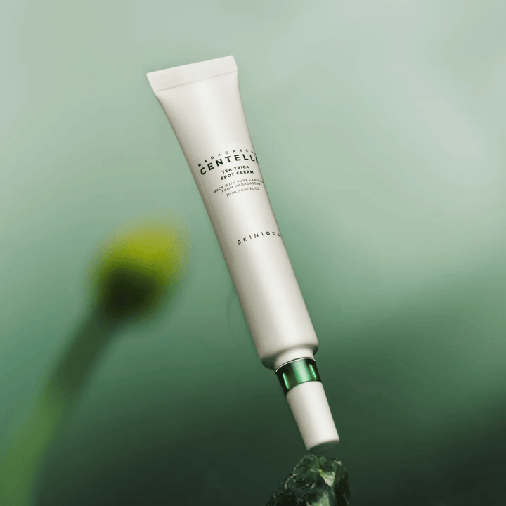 SKIN1004 Madagascar Centella Tea-Trica Spot Cream floating against a green background – effective spot treatment for acne-prone skin with centella from Madagascar.