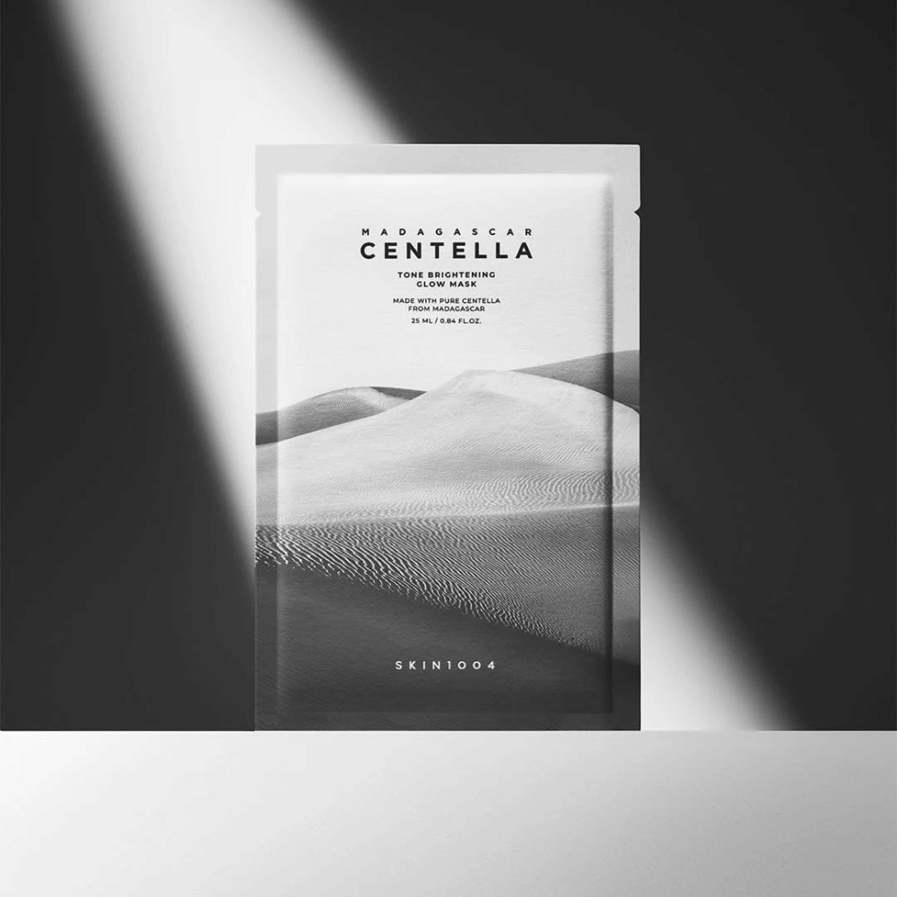 A mask standing in the spotlight with sharp shadows for a premium feel.