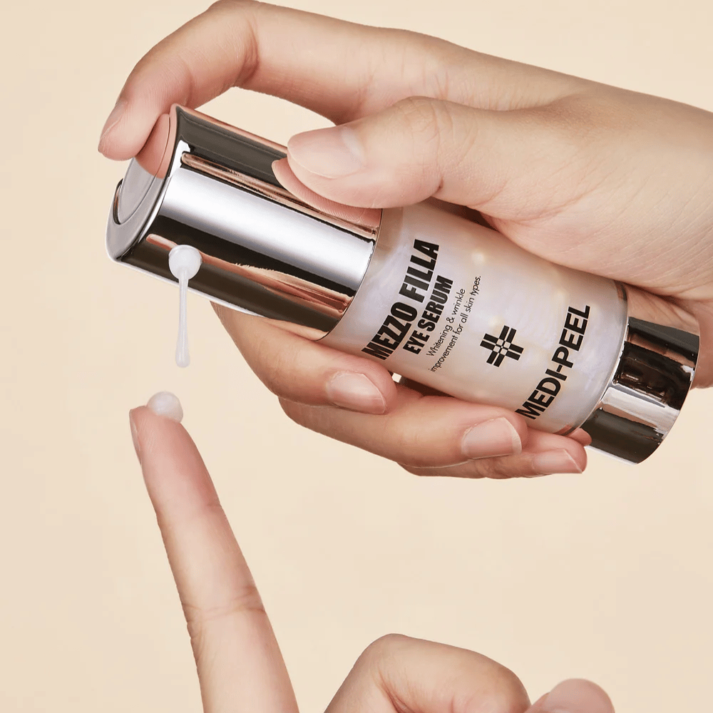 Application of MEDI-PEEL Mezzo Filla Eye Serum on fingertip – lightweight eye serum that absorbs quickly and provides intense moisture and anti-aging effect.