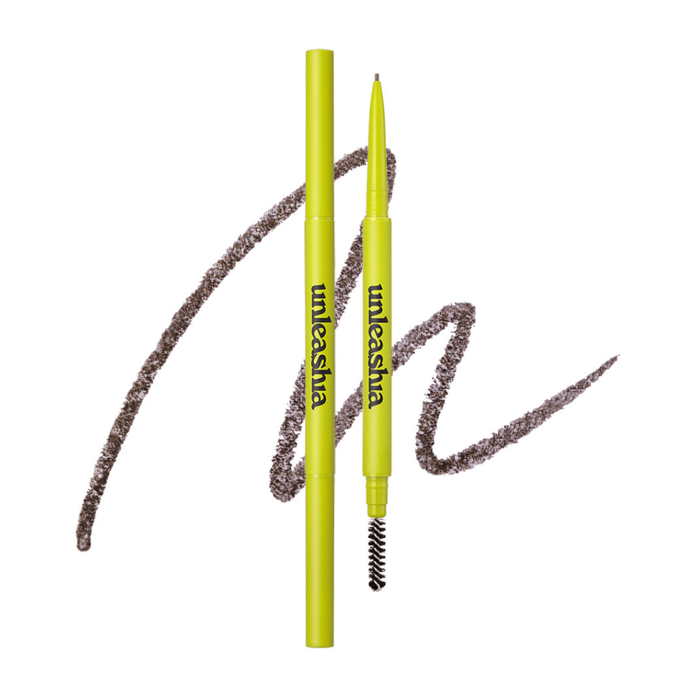 The image shows UNLEASHIA's eyebrow pencil in the color "N°2 Kraft Brown". The product is presented with its two ends: a precision pencil for filling in and defining the shape of the eyebrows and a brush to soften and blend the color. The packaging is light green, giving a fresh and modern feel.