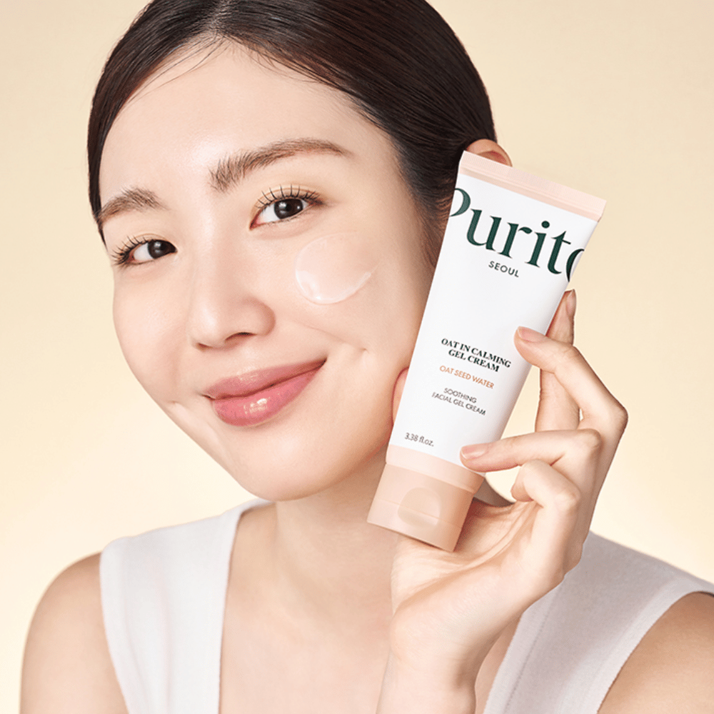 Woman applies Purito Oat-In Calming Gel Cream on the face. Mild and moisturizing gel cream for sensitive and irritated skin.