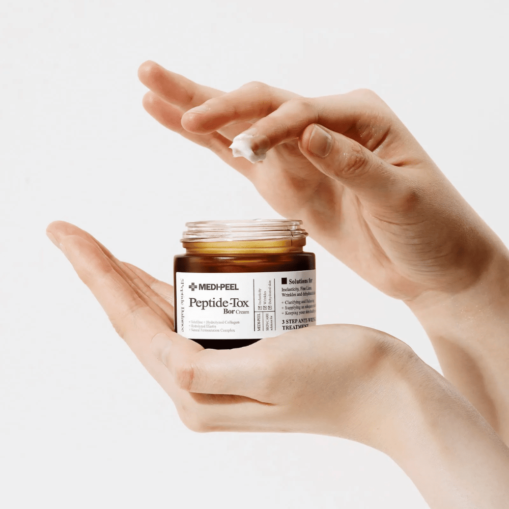 Application of MEDI-PEEL Peptide-Tox Bor Cream – Korean face cream with peptides that improve skin elasticity, provide deep hydration, and help reduce wrinkles.