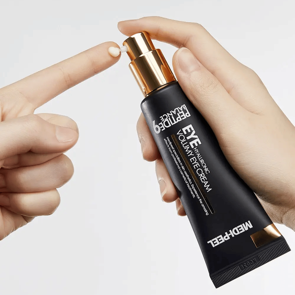 Application of MEDI-PEEL Peptide 9 Hyaluronic Volumy Eye Cream on fingertip – moisturizing eye cream with peptide complex that helps reduce fine lines and provide plumped skin.