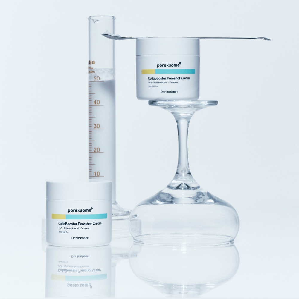 Two jars of Dr.nineteen Porexsome CollaBooster Poreshot Cream placed next to a glass and measuring cup. Minimalist design that signals scientific precision.