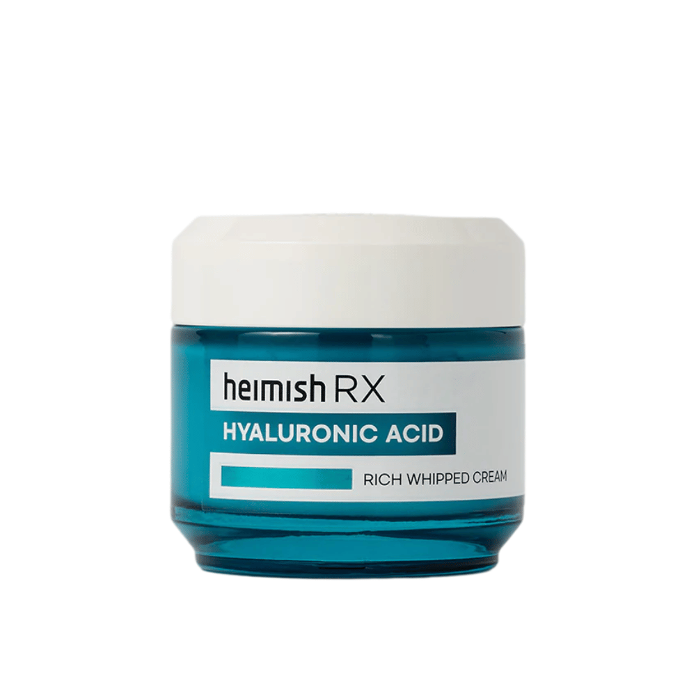 Heimish RX Hyaluronic Acid Rich Whipped Cream in a sleek blue glass jar with a white lid. A nourishing face cream with hyaluronic acid for intense hydration and soft, plump skin.