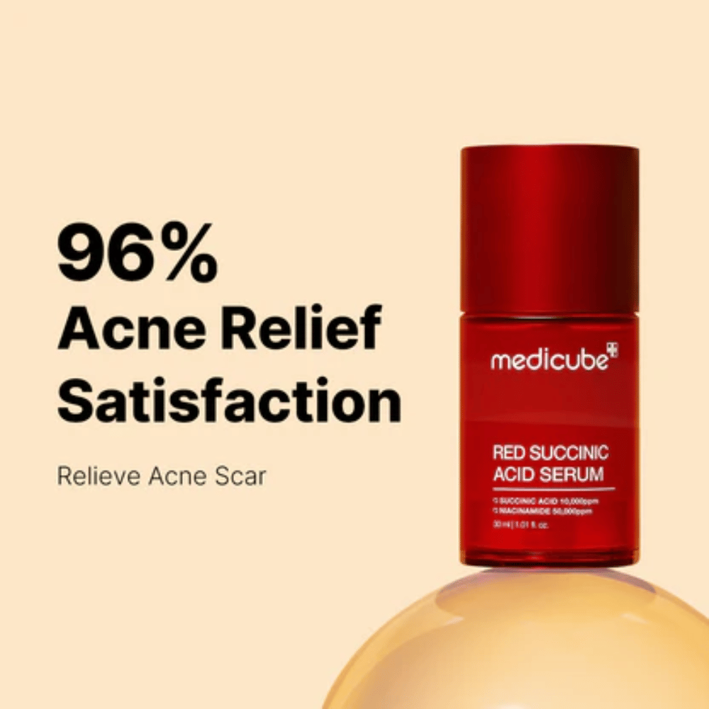 Medicube Red Succinic Acid Serum in red pump bottle, shown against a beige background with the text “96% Acne Relief Satisfaction”. The product is developed to reduce acne scars and soothe the skin.