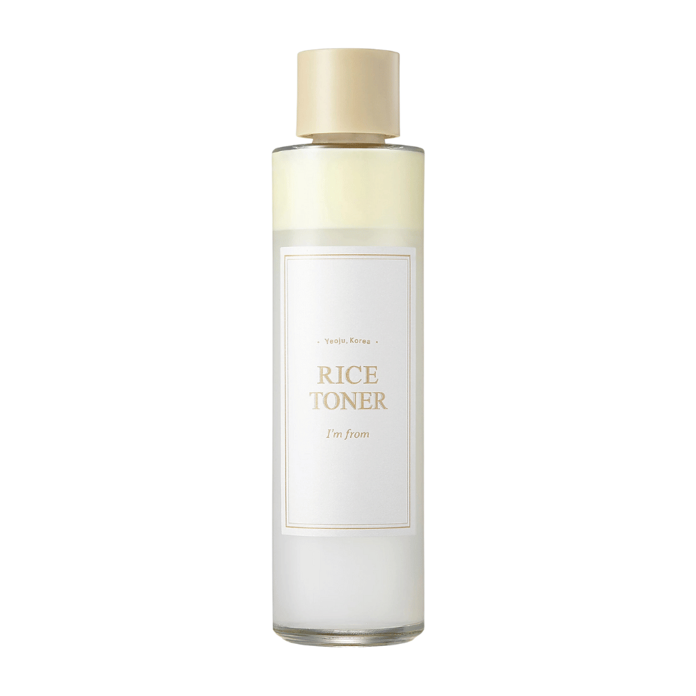 A transparent bottle with a gold cap and a label indicating "Rice Toner I'm from Yeojü, Korea". The bottle contains a light liquid, presumably a toner based on rice extract. The design is clean and minimalist. The background is white.