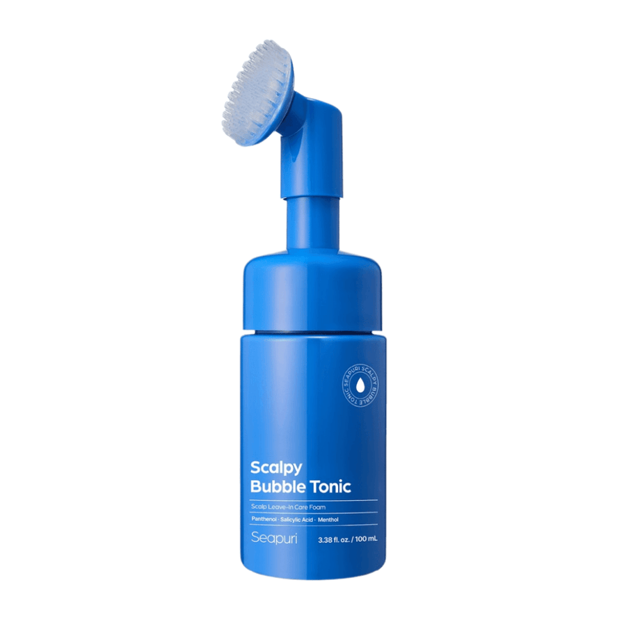 Cut-out product image of Seapuri Scalpy Bubble Tonic showing the blue bottle with a built-in silicone brush for easy and hygienic application directly to the scalp.