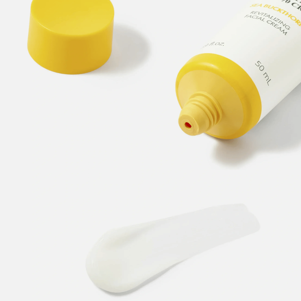 1. Purito SEOUL Sea Buckthorn Vital 70 Cream – close-up of the face cream's light white texture next to an open tube with a yellow cap