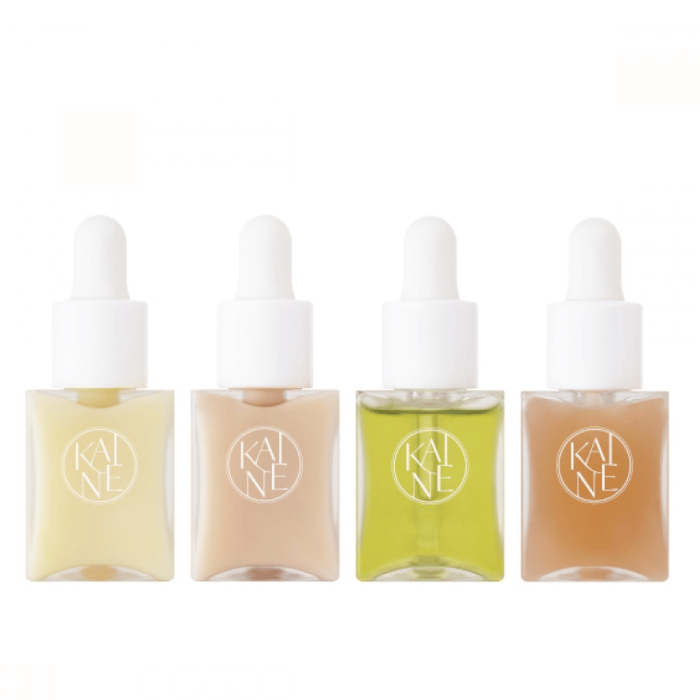 Four colorful serum bottles from KAINÉ Serum Discovery Kit with pipette caps, designed to meet various skin needs in a minimalist and sleek packaging.