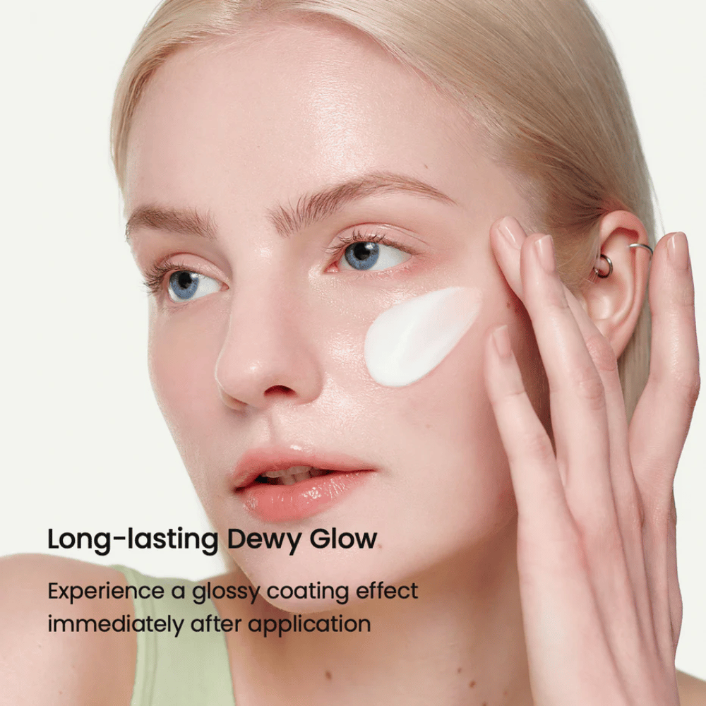 Close-up of a woman with fair skin applying Biodance Skin-Glow Essence Cream on the cheek, giving an instant glossy and hydrated appearance with long-lasting radiance.