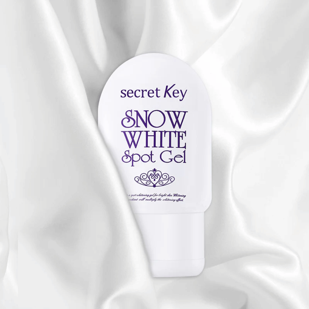 Secret Key Snow White Spot Gel placed on a white silk-like fabric background.