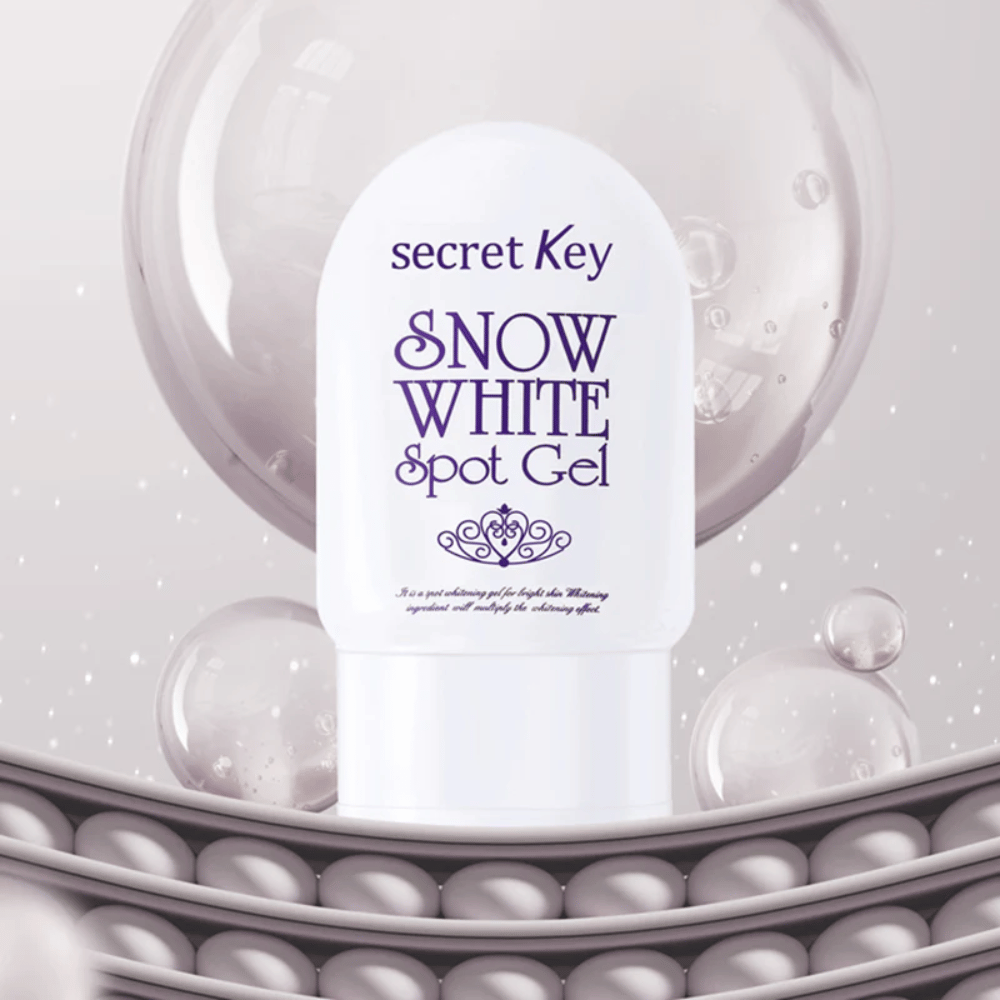 Secret Key Snow White Spot Gel in white packaging against a background with bubbles and pearl-like details.