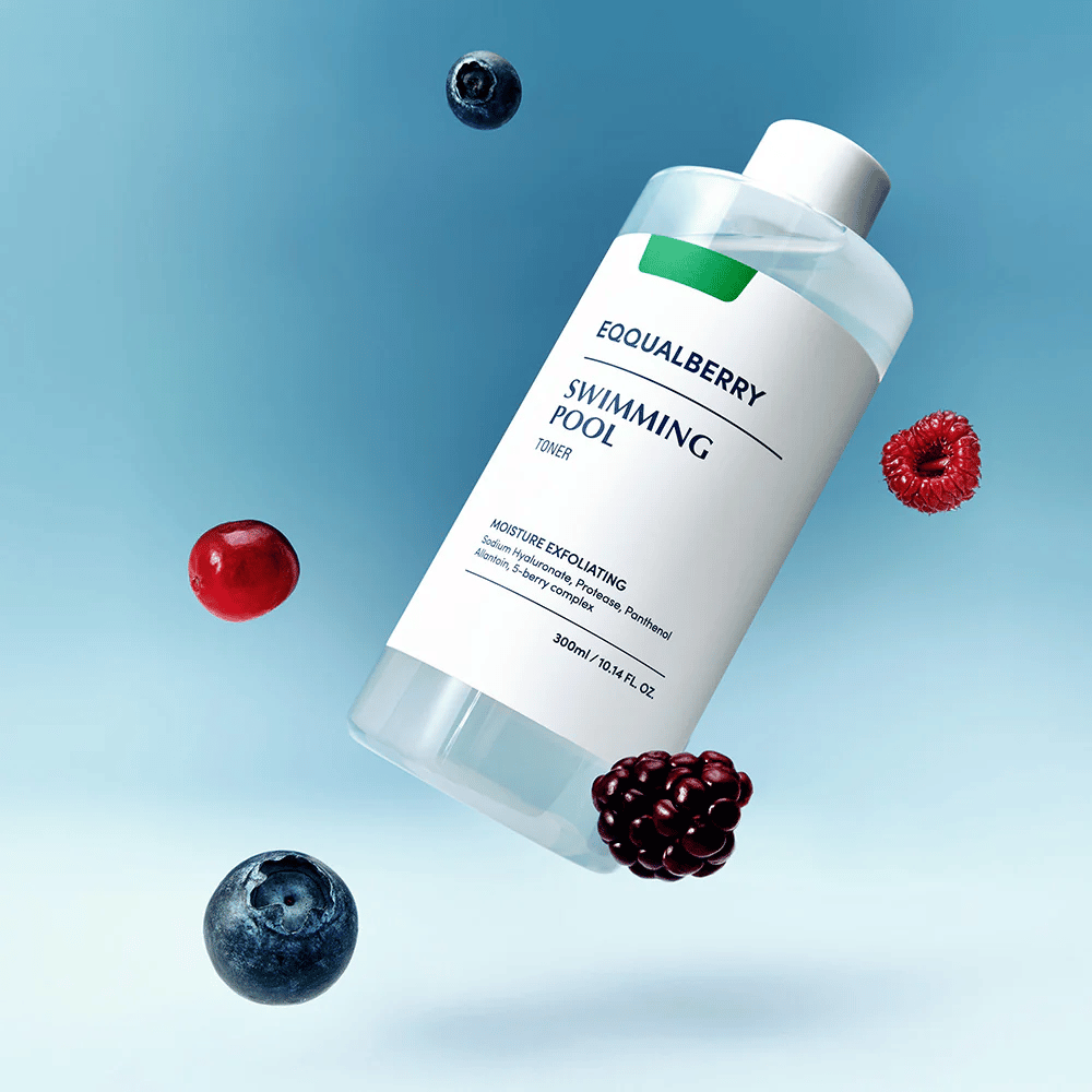 Equalberry Swimming Pool Toner in a sleek bottle floating against a blue background, surrounded by fresh berries like blueberries, raspberries, and blackberries.
