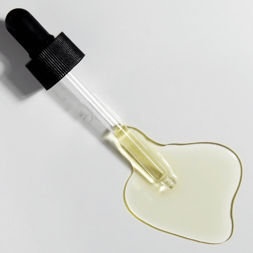 Close-up of pipette with COSRX The Vitamin C 13 Serum and golden Vitamin C formula, concentrated serum with vitamin E and hyaluronic acid.