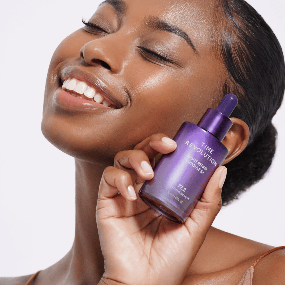 4. MISSHA Time Revolution Night Repair Ampoule 5X – model holding purple night serum for facial care and radiance