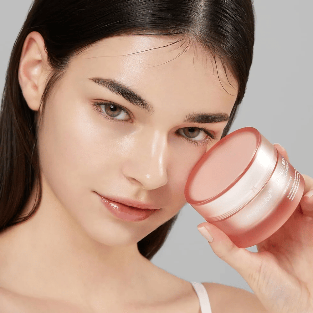 The image shows a woman holding a jar of Triple Collagen Cream. The cream is designed to improve skin elasticity and hydration. The woman's skin looks smooth and well-cared for.




