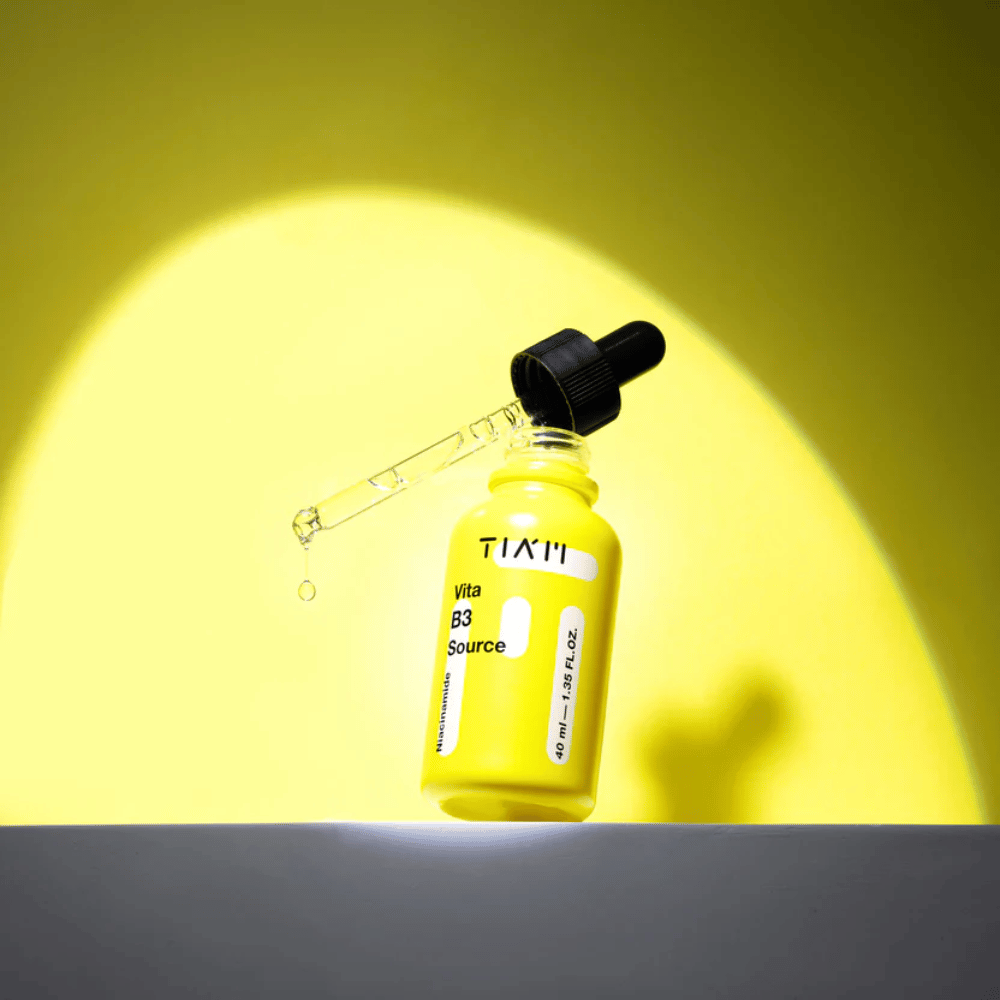 TIA'M Vita B3 Source – Niacinamide serum in a yellow bottle with a pipette, designed to brighten the skin and provide a clearer skin tone.