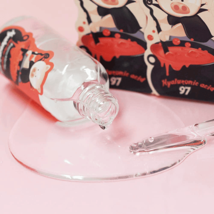 Close-up of Elizavecca Hyaluronic Acid 97 with pipette and clear serum texture that absorbs quickly and deeply hydrates the skin.