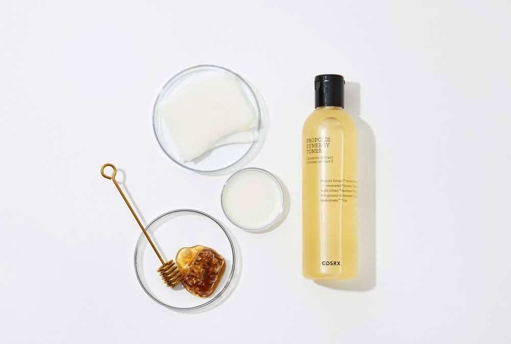 A bottle COSRX Full Fit Propolis Synergy Toner 150ml with anti-inflammatory and antibacterial effects, placed on a white surface.
